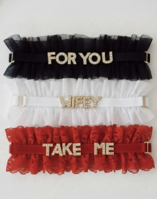 Three garters with text 'FOR YOU', 'WIFEY', and 'TAKE ME' on a white background
